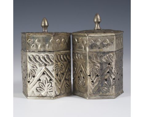 DESCRIPTION: Pair of metallic trinket boxes. Features repousse floral designs along with trianguar reticulations. CIRCA: 20th