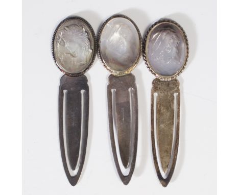 DESCRIPTION: Ari D. Norman, London silversmith, sterling art nouveau pins. Features mother of pearl cameos of smiling women, 