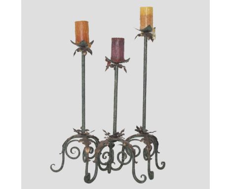 DESCRIPTION: Set of three Cast iron candle holders at various heights. Features three spiraling legs embellished with coppere