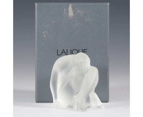 DESCRIPTION: Lalique frosted crystal nude "Nahbi" figurine. Features a nude figure seated with his legs crossed, with his hea