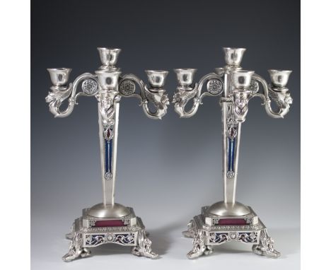 DESCRIPTION: Silverplated candelabras by Linea Argenti. Features four scrolled baroque candle sticks, surrouding the center, 