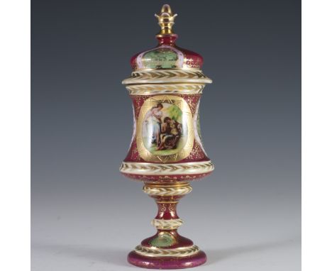 DESCRIPTION: Royal Vienna porcelain urn. Features a rendering of a partially nude woman in flowing garbs holding a string of 
