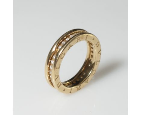 DESCRIPTION:A Bvlgari wedding band comprising of 18kt yellow gold band and embellished with prong set diamonds. Marked:"Bvlga