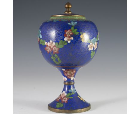 DESCRIPTION: Chinese cloisonne enameled urn. Features a pear shaped body resting on a fluted base. Decorated with blue enamel