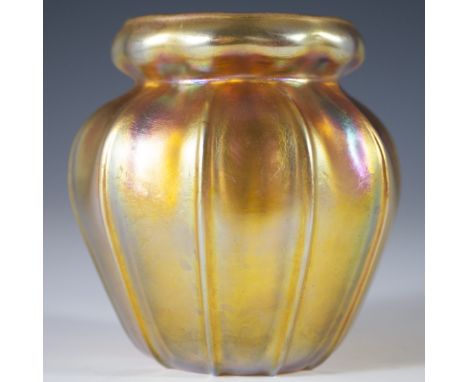 DESCRIPTION: Antique Louis Comfort Tiffany favrile glass vase. Features a bud form with ridged arching exterior and yellow gr