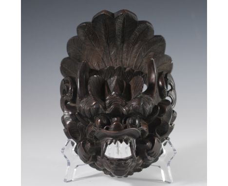 DESCRIPTION: A carved wooden face of the Solomon Islands, Guardalcanal, Wind God. Intricately detailed with fierce fangs and 