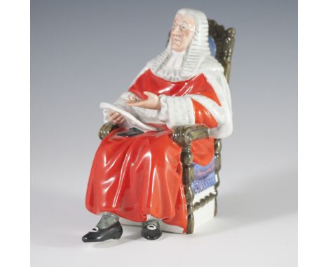 DESCRIPTION: Royal Doulton porcelain figurine titled:"The Judge". Features a judge seated in a regal arm chair, draped in tra