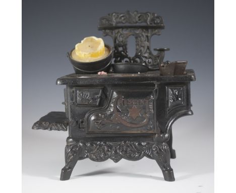 DESCRIPTION: Crescent cast iron salesman stove. Features a model stove that door to door salesmen would use to sell their sto