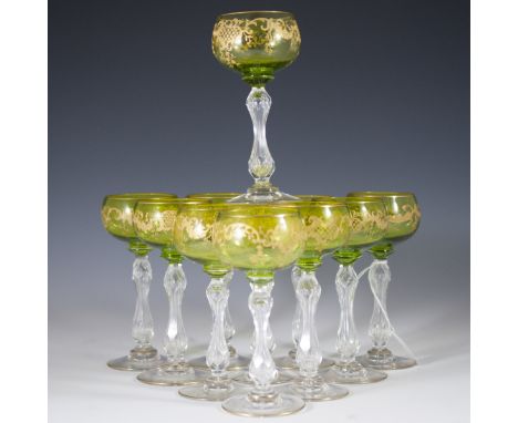 DESCRIPTION: Set of 11 continental crystal wine goblets. Features a green hue along the top with gilded rococo designs. Finis