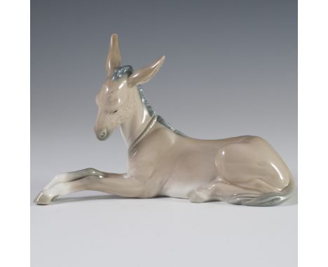 DESCRIPTION: Lladro porcelain figurine of a donkey lying down. Handpainted with a glossed glaze and marked:"Lladro Handmade i