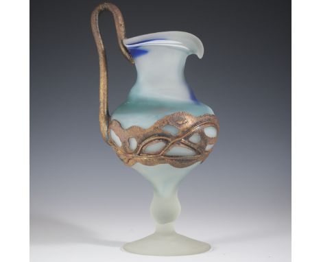 DESCRIPTION: Pate de verre glass jug featuring swirling turquoise, white and blue hues. Finished with coppered handle and acc