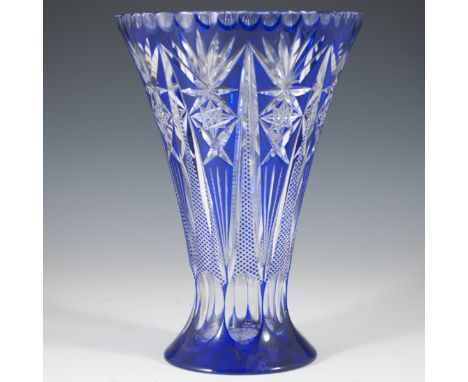 DESCRIPTION: Cobalt Bohemian glass vase. Features an overall fluted design with a rich cobalt blue hue with ornate linear, sy