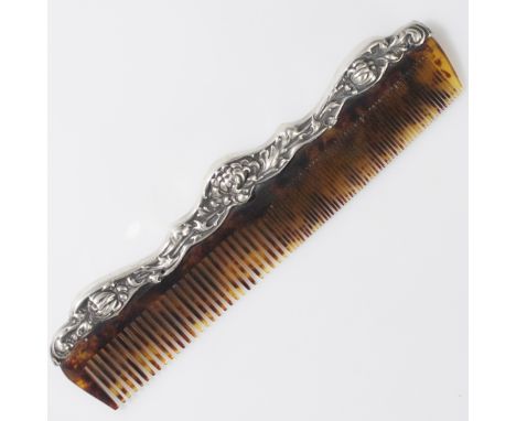 DESCRIPTION: Antique sterling comb. features a sterling handle with embossed rococo floral motif. Marked:"Sterling"CIRCA: Ear