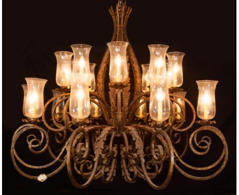 DESCRIPTION: A gorgeous palace size cast iron chandelier. Around each lightbulb is a lantern glass. This chandelier contains 