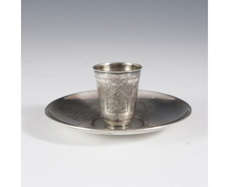 DESCRIPTION: Russian silver thimble cup and saucer. Cup is engraved with village scape and intricate designs and marked:"NEZ"