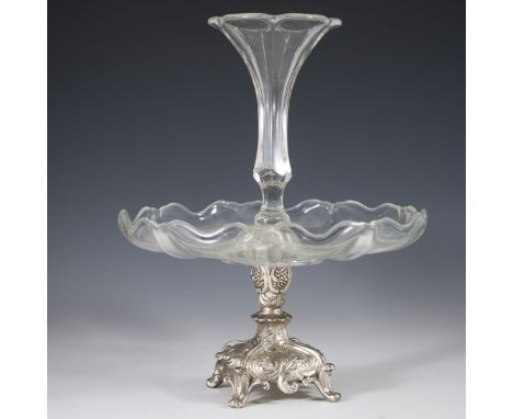 DESCRIPTION: Silverplated centerpiece featuring a glass bowl centered by a pertruding faceted glasse vase. The base is embell