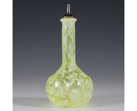 DESCRIPTION: Vibrantly hued glass barber bottle. Features a textured exterior with a yellow hue and white accents in a floral