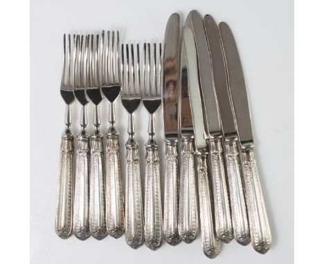 DESCRIPTION: Solingen 800 silver flatware set. Feature silver handles with ornate rococo embossed motif and stainless steel b