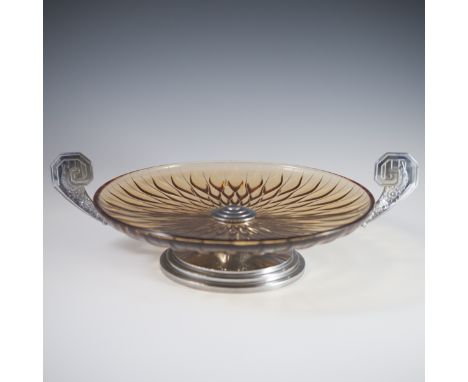 DESCRIPTION: An amber glass tray featuring ornate crystal cuts and flanked by petwer handles with linear and scrolled embosse