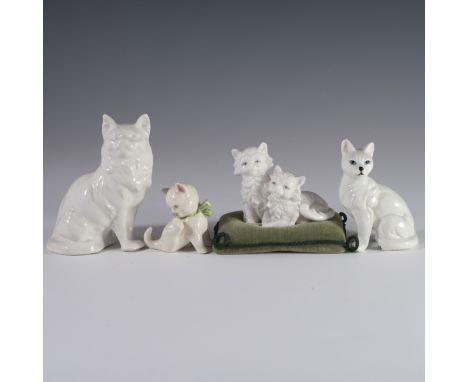 DESCRIPTION: A porcelain cat assortment. One features a simplistic all white cat peering to its side, one licking is paw, two
