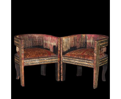 DESCRIPTION: Vintage Morroccan arm chairs. Features painted leather cushions in traditional patterns along with silvered meta