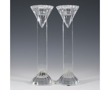 DESCRIPTION: Ornate crystal candlesticks. Features a ridges traingular fluted top that extends into a rectangular stem and si
