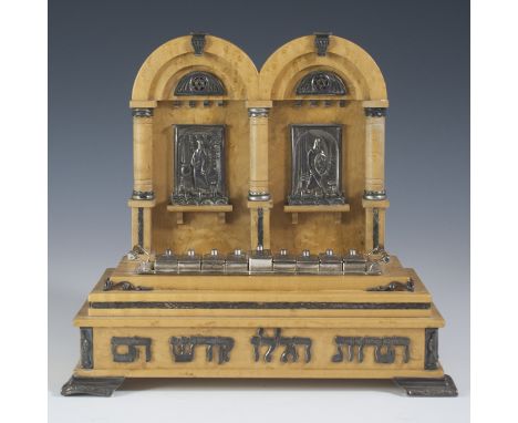 DESCRIPTION: Itzhak Luvaton wooden menorah designed with two arching domes along the back panel and plaques with reliefs of o