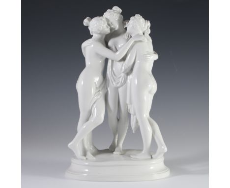 DESCRIPTION: Sitzendorf porcelain figurine of the classical three graces embracing one another, standing atop an oval beveled