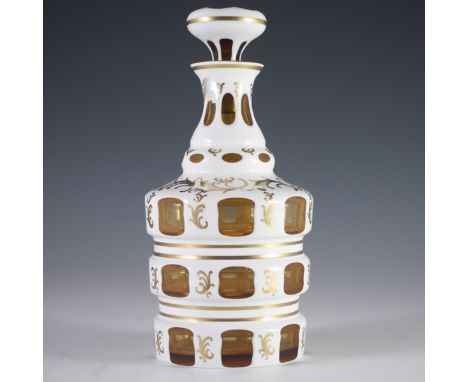 DESCRIPTION: Bohemian ambery crystal overlay decanter. Features three tiered octagonal segments with gilded rococo motif and 