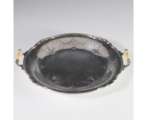 DESCRIPTION: Wilcox silverplated tray embellished with embossed rococo designs with fruits and strings of flowers. Flanked by