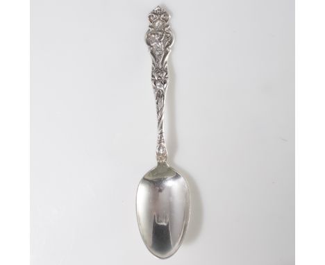 DESCRIPTION: R. Wallace & Sons sterling spoon. Features an Art Nouveau motif embossed handle with the rendering of a nude nym