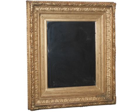 DESCRIPTION: Antique gilded wood mirror finely handcarved with rococo acanthus leaves, a Greco-Roman patterns encompassing th