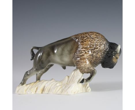 DESCRIPTION: Vintage porcelain Goebel figurine of a bison charging along a textured base. Handpainted in a glossed glaze and 