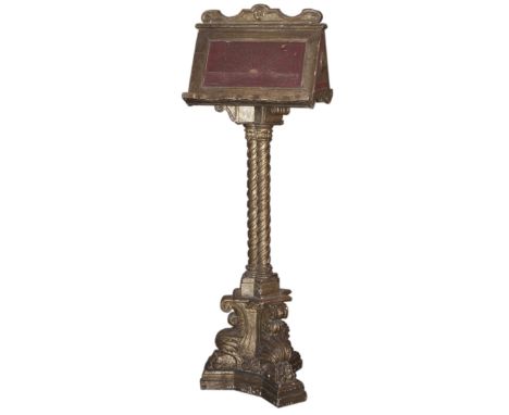 DESCRIPTION: An antique gilded wood lectern. Comprises of griffin pawed feet that extends upwards into a triple spiraled stem