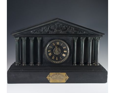 DESCRIPTION: An antique slate manlte clock featuring a Greco-Roman structured design with embossed carved Mythical figures al