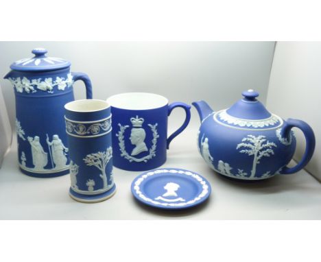 A Wedgwood dark blue Jasperware teapot, mug, pitcher,  and cylindrical vase and pin tray 