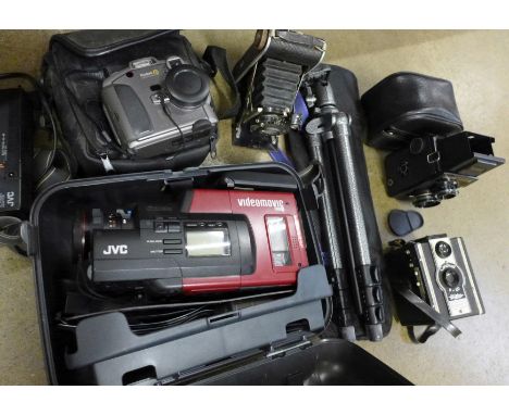 A Lubitel 166B camera, a Coronet F-20 camera, a Kodak DC260 zoom camera, a folding camera and a JVC video movie camera and a 