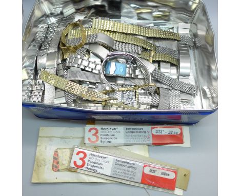 A collection of over 40 men's stainless steel watch straps and expandable watch straps, new old stock, longcase clock hands, 