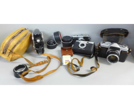 A Kowa Company SLR camera, with additional lens, Olympus Trip 35 camera, Comet camera, light meter and a Quarz cine camera ou