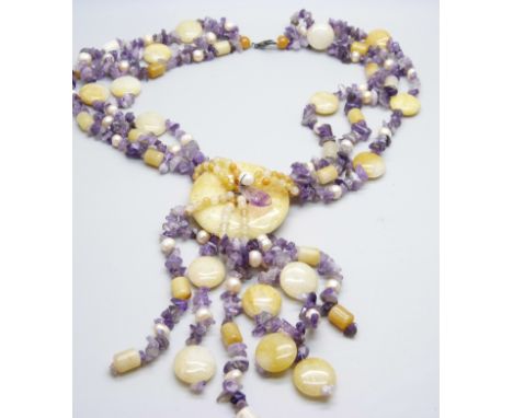 A string of amethyst, pearl and hardstone beads with silver mount 