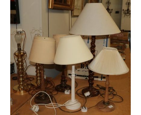 A pair of brass candlestick form table lamps, together with a pair of tapering wooden table lamps and three other wooden tabl