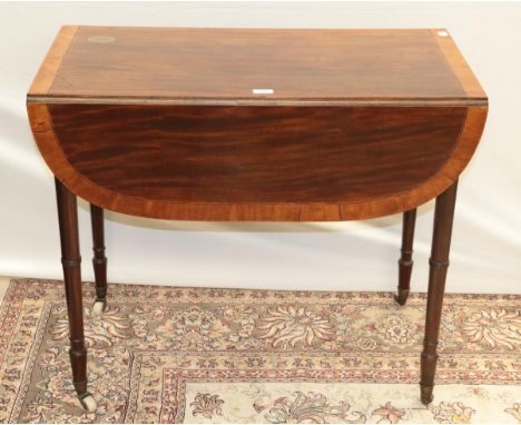 A late George III mahogany and satinwood cross banded Pembroke table, on ring turned tapered legs with white ceramic castors,