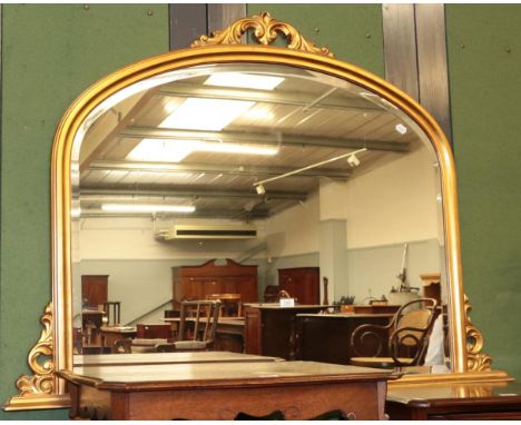 A large gilt framed arched top over mantel mirror, 144cm by 102cm 