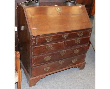 A George III mahogany fitted bureau with pierced brass handles and raised on bracket supports, 91cm by 50cm by 98cm 