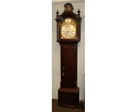 An oak eight-day longcase clock, 13'' arched brass dial with silvered chapter ring, the arch with silvered plaque bearing an 