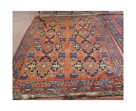 A Caucasian red ground carpet with geometric designs, 120" x 76"