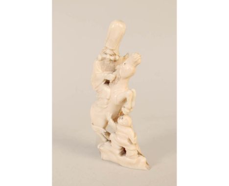 A vintage Chinese ivory carving of a mounted sage and boy, height 6"