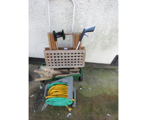 SMALL QUANTITY OF GARDENING HAND TOOLS TOGETHER WITH GARDEN HOSE ON WHEEL, UNIVERSAL SPREADER CART, AND A SMALL FOLDING WOODE