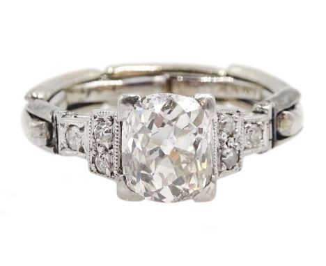 Art Deco platinum diamond ring, the central cushion cut diamond of approx 1.10 carat, with three diamonds either side, on a l