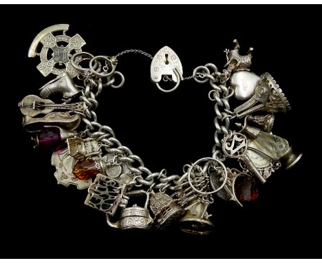 Heavy silver curb chain bracelet, with various charms including rabbit in a hut, money box teapot, guitar, clown, keys bell -